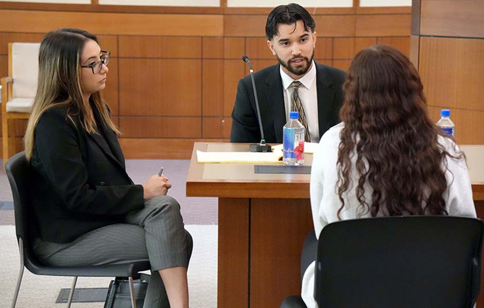 Photo of three people having a discussion